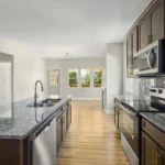 For your main image, use: "Modernized kitchen cabinets with unlacquered brass hardware for 2026.