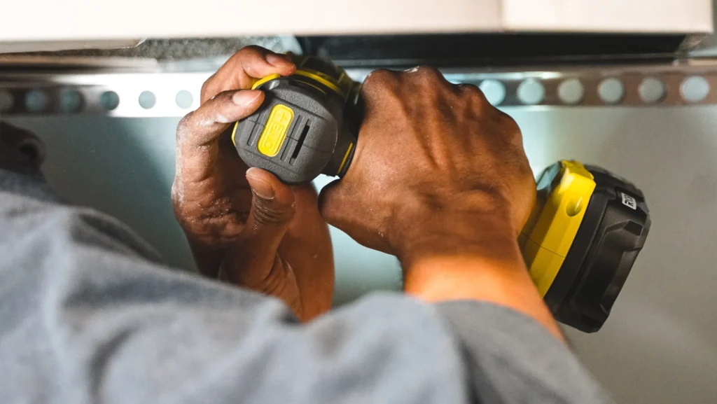 DIY cabinet hardware installation using a basic drill, budget kitchen upgrade.