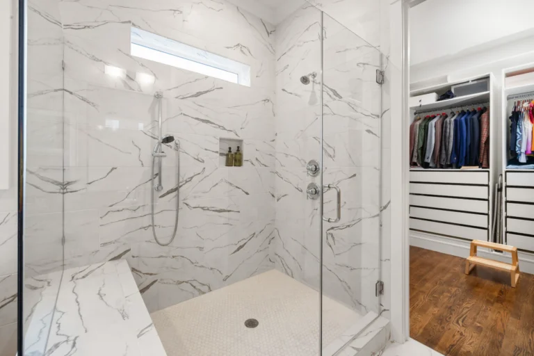 Aging in place home modifications showing curbless walk-in shower with safety grab bars.