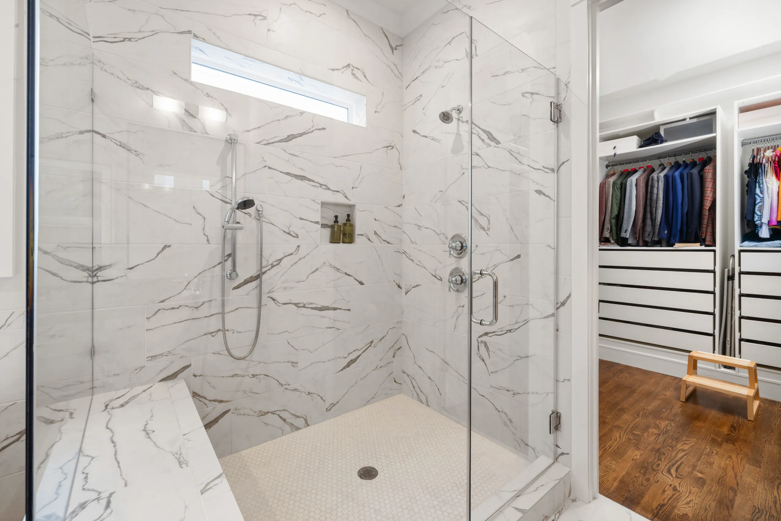 Aging in place home modifications showing curbless walk-in shower with safety grab bars.