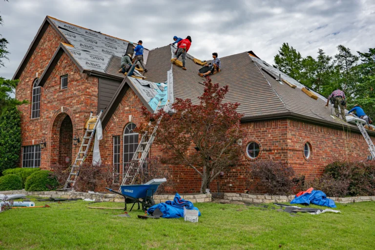 Homeowner cleaning gutters to prevent roof water damage.