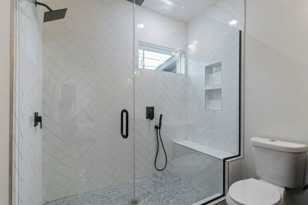 aging in place home modifications. Curbless walk-in shower with grab bars and built-in bench for aging-in-place bathroom safety.